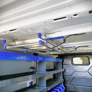 E-Flex ladder holder for a van mounted on the ceiling of a Ford Transit Custom, keeping ladders secure and the cargo floor clear.