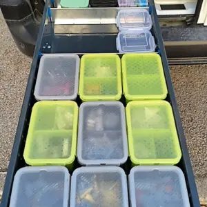 Portuguese customers installing long drawer units in a van and showing organized storage