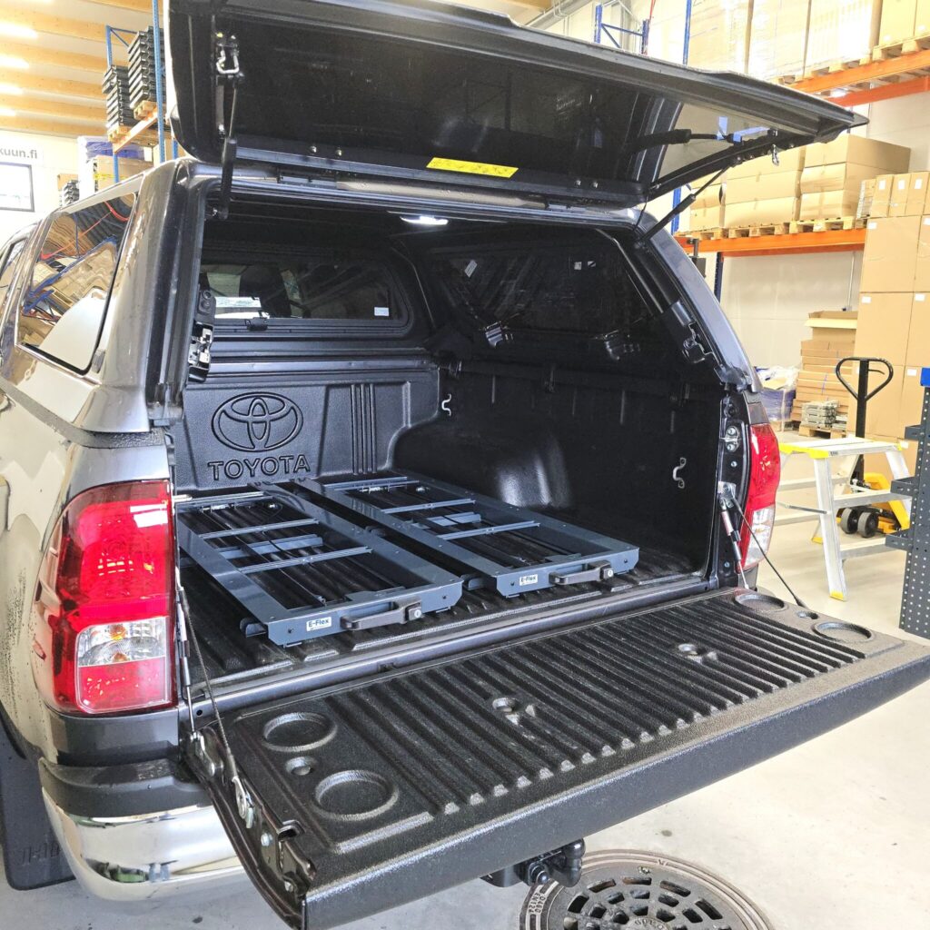 Pull-out loading platform installed in Toyota Hilux pick-up for easy access to tools and heavy equipment