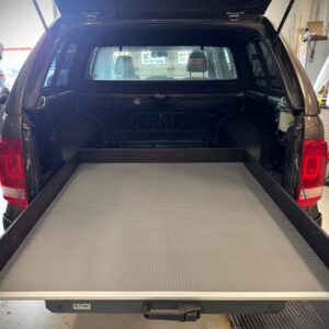 Pull-out loading platform installed in pickup truck bed for easy access to tools and cargo