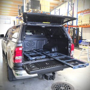 Pull-out loading platform installed in Toyota Hilux pick-up for easy access to tools and heavy equipment