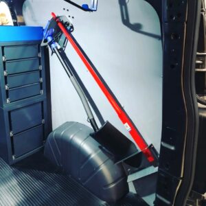Shovel and pry bar holder installed diagonally on the van side wall